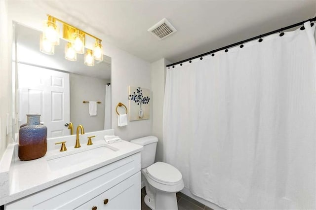 bathroom with tile patterned flooring, vanity, and toilet