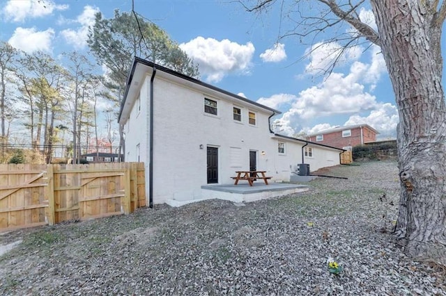 rear view of house featuring a patio and central AC unit