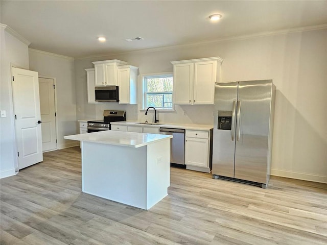 228 Trellis Walk, Macon, GA 31220 - kitchen featuring stainless steel appliances, a sink, white cabinetry, ornamental molding, and light wood-style flooring