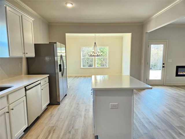 228 Trellis Walk, Macon, GA 31220 - kitchen featuring stainless steel dishwasher, light wood-style flooring, a chandelier, light countertops, and crown molding