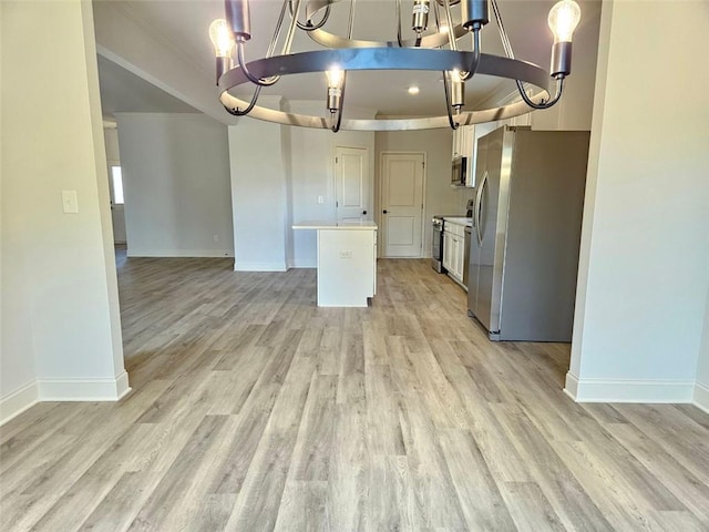228 Trellis Walk, Macon, GA 31220 - kitchen featuring appliances with stainless steel finishes, a chandelier, baseboards, light countertops, and light wood-style flooring