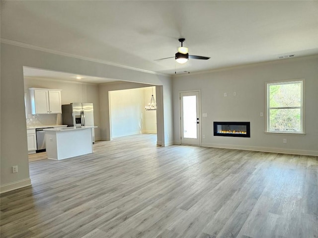 228 Trellis Walk, Macon, GA 31220 - unfurnished living room with crown molding, ceiling fan, light wood finished floors, baseboards, and a glass covered fireplace