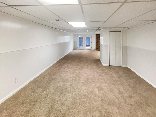 6354 Shannon Pkwy Unit 8B, Union City, GA 30291 - unfurnished living room with a drop ceiling, carpet flooring, a brick fireplace, and french doors