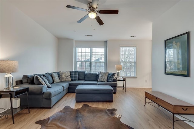 living room with ceiling fan and light wood-type flooring