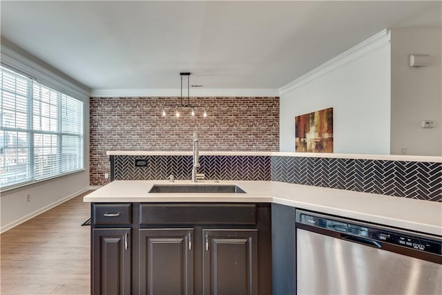 kitchen featuring dark brown cabinetry, sink, crown molding, decorative light fixtures, and dishwasher