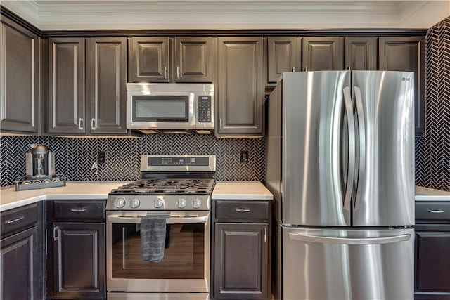 kitchen featuring crown molding, dark brown cabinetry, stainless steel appliances, and backsplash