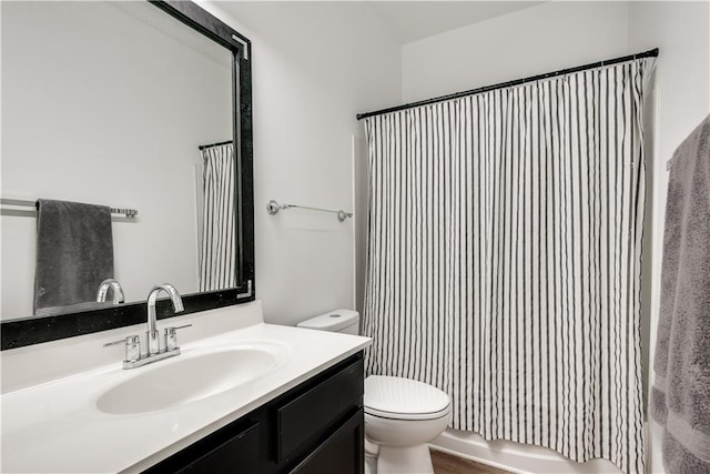 full bathroom with vanity, shower / tub combo, and toilet