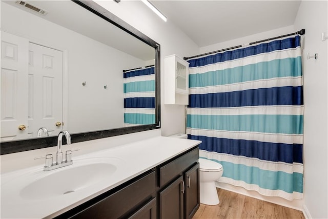 bathroom featuring hardwood / wood-style flooring, vanity, and toilet