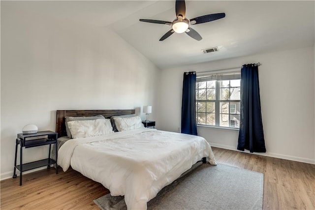 bedroom with lofted ceiling, ceiling fan, and light hardwood / wood-style flooring