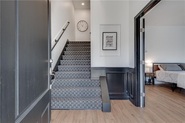 stairs with hardwood / wood-style floors