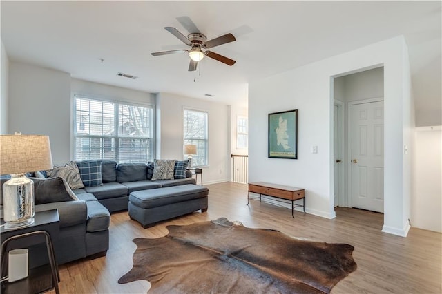 living room featuring ceiling fan and light wood-type flooring