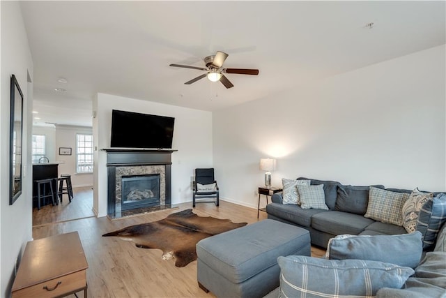 living room with ceiling fan and light wood-type flooring