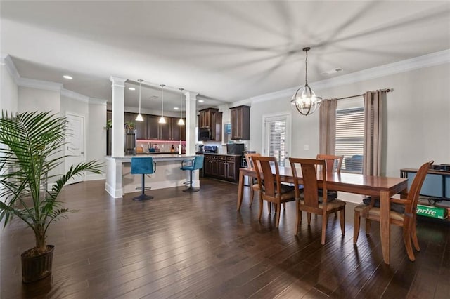 dining space featuring dark hardwood / wood-style flooring, an inviting chandelier, and ornamental molding