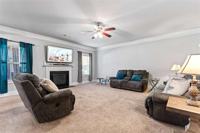 carpeted living room with ceiling fan and ornamental molding