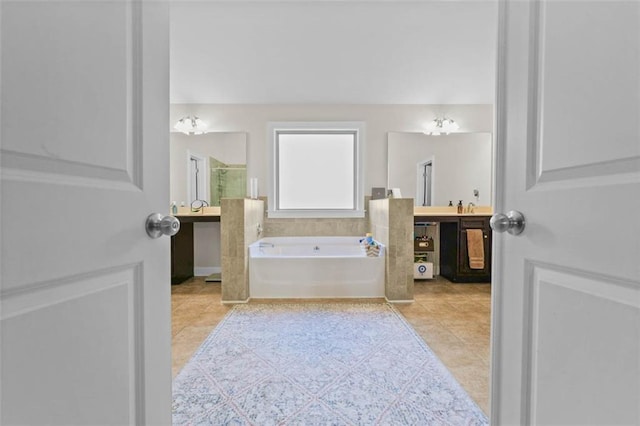 bathroom featuring a washtub, tile patterned floors, vanity, and a chandelier