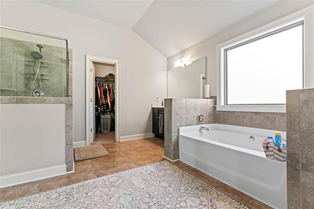 bathroom featuring plus walk in shower, lofted ceiling, and vanity