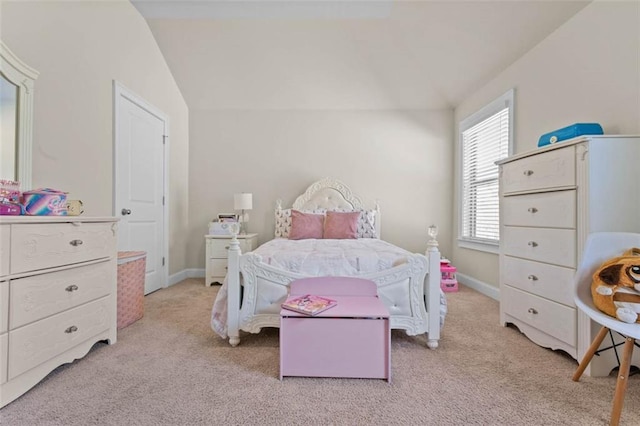 bedroom with lofted ceiling and light carpet