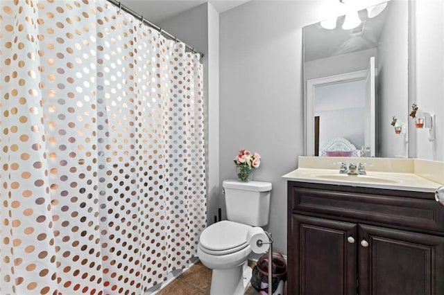 bathroom featuring toilet, tile patterned flooring, and vanity