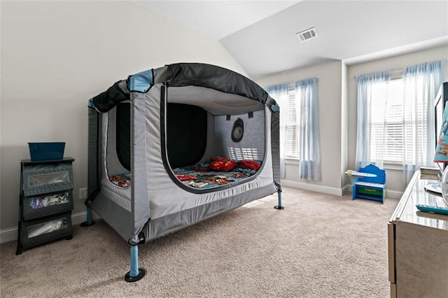 carpeted bedroom with vaulted ceiling