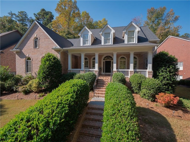 cape cod-style house with a porch