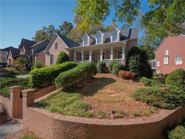 cape cod-style house with a porch