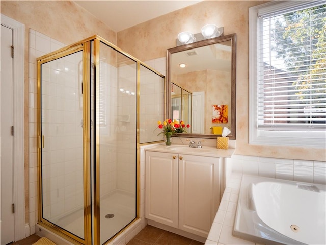 bathroom featuring vanity, independent shower and bath, and tile patterned floors