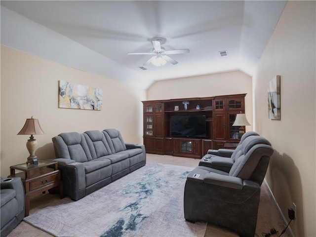 carpeted living room featuring vaulted ceiling and ceiling fan