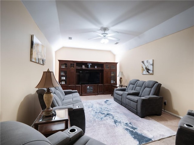 living room featuring vaulted ceiling, light carpet, and ceiling fan