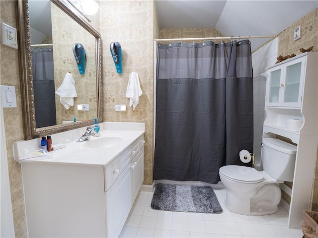 bathroom with lofted ceiling, toilet, vanity, tile patterned floors, and a shower with shower curtain