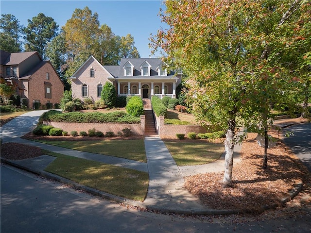 new england style home featuring a front lawn