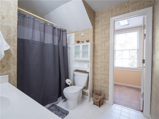 bathroom with toilet, walk in shower, vanity, and tile patterned floors