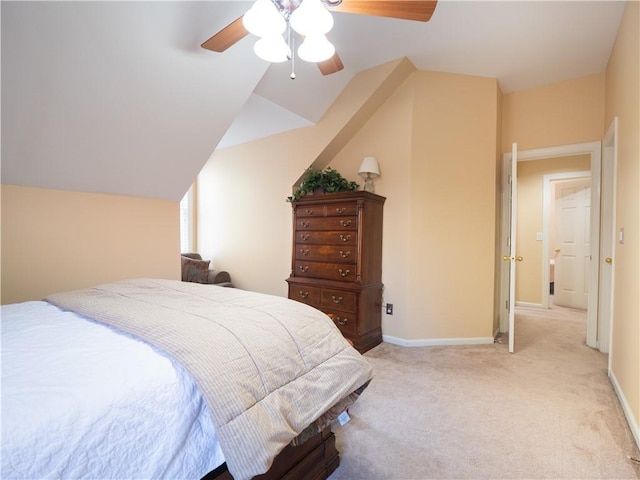 bedroom featuring vaulted ceiling, light colored carpet, and ceiling fan