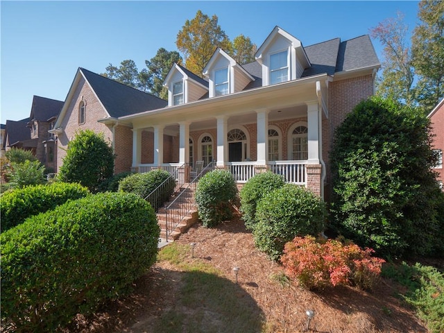 new england style home featuring a porch