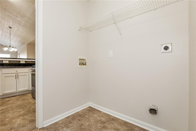 clothes washing area featuring a notable chandelier, hookup for a washing machine, hookup for an electric dryer, laundry area, and baseboards