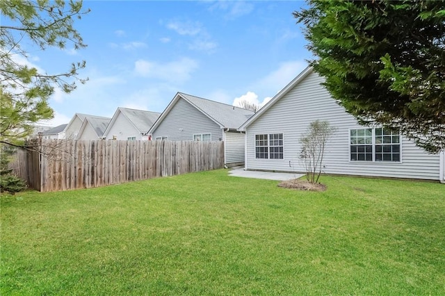 view of yard featuring fence and a patio