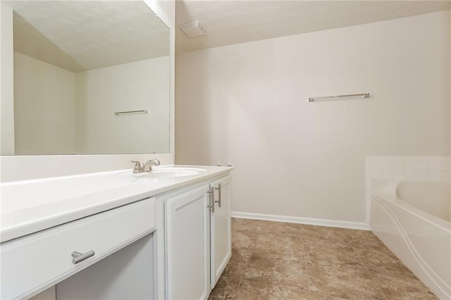 full bath with a garden tub, baseboards, visible vents, and vanity