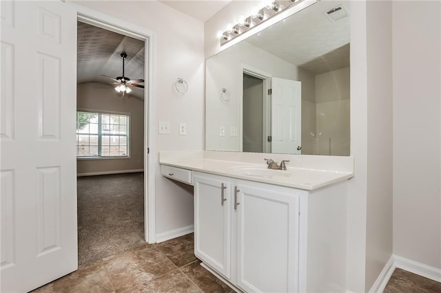 bathroom with lofted ceiling, visible vents, baseboards, and vanity