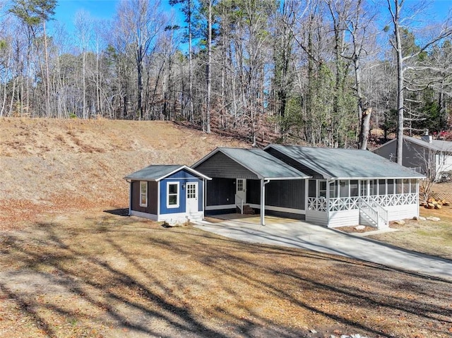 ranch-style house with a front yard and a carport