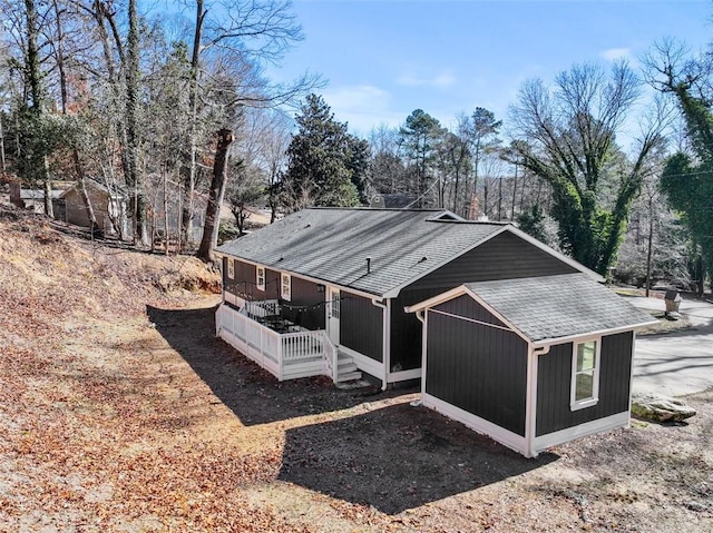 view of side of property with covered porch