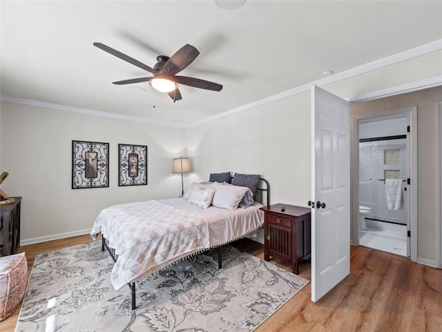 bedroom with connected bathroom, wood-type flooring, and ornamental molding