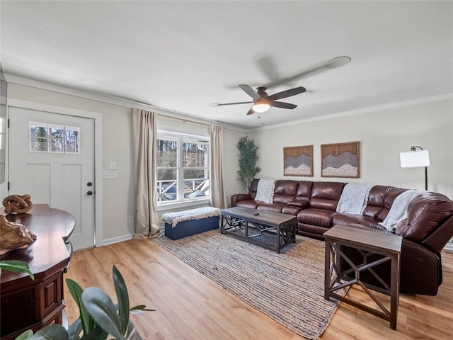 living room with crown molding, light hardwood / wood-style floors, and ceiling fan