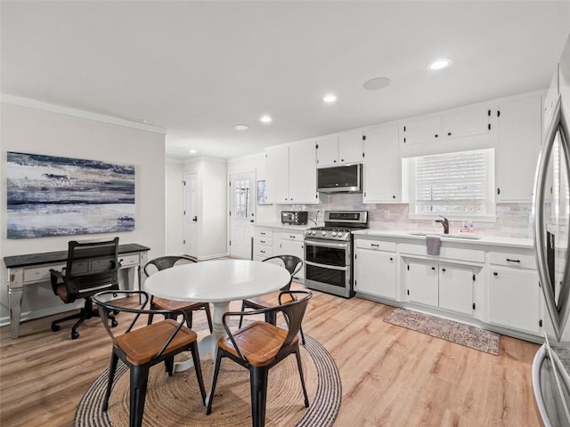 kitchen featuring stainless steel appliances and white cabinets