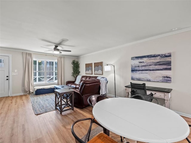 dining room featuring light hardwood / wood-style flooring, ornamental molding, and ceiling fan