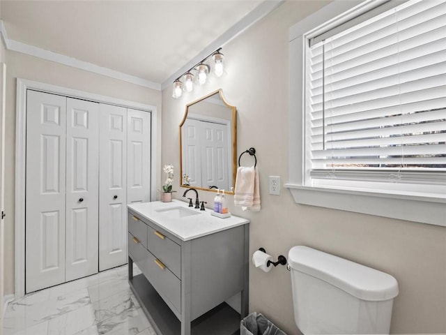 bathroom with vanity, ornamental molding, and toilet