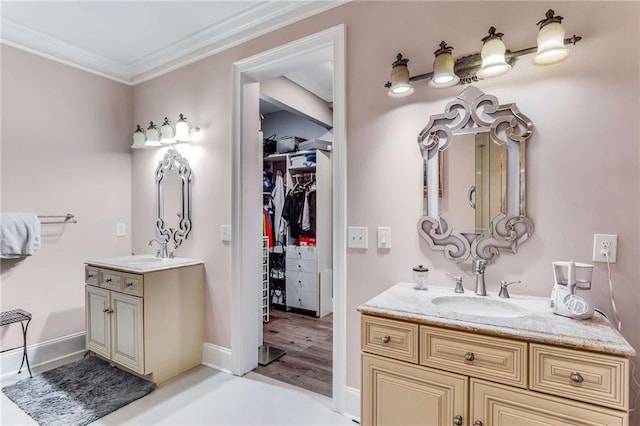 bathroom featuring dual vanity, a tub to relax in, hardwood / wood-style floors, and ornamental molding