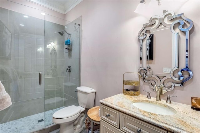 bathroom with a shower with door, toilet, vanity, and ornamental molding