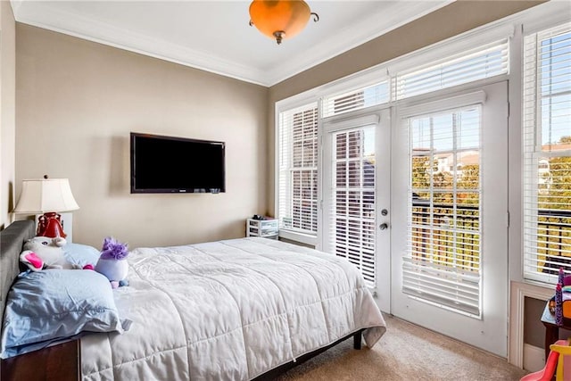 carpeted bedroom with access to outside and ornamental molding