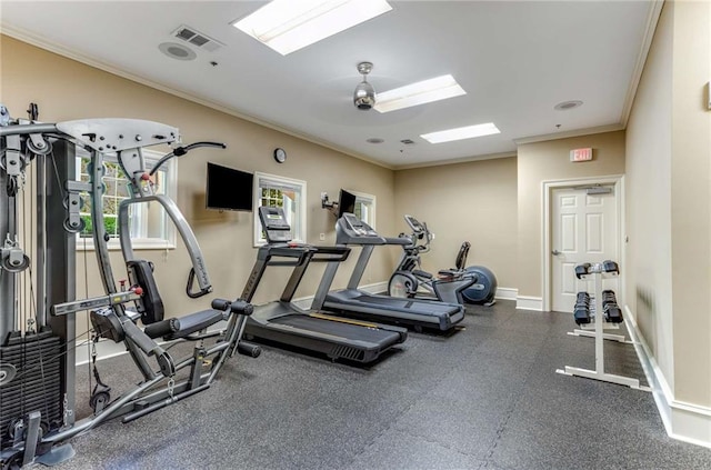 workout area with ornamental molding and a healthy amount of sunlight