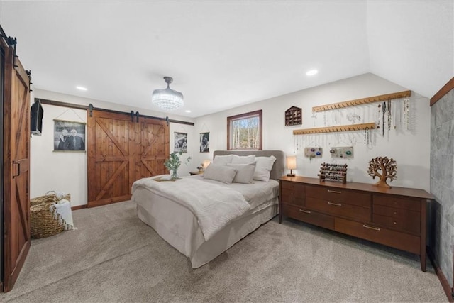 bedroom with a barn door, recessed lighting, light colored carpet, and lofted ceiling