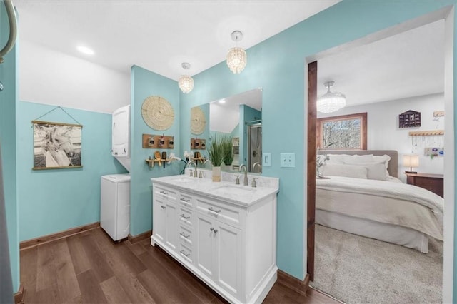 bathroom featuring wood finished floors, ensuite bathroom, and a sink